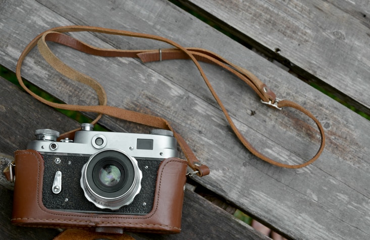 An old film camera on a wood surface