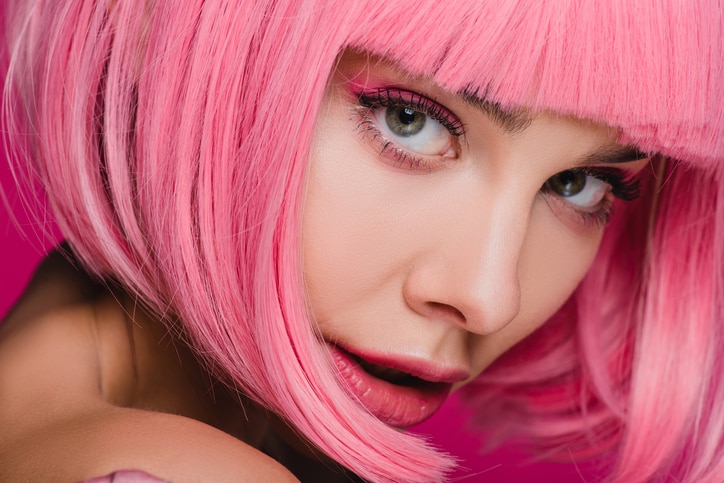 charming fashionable girl posing in pink wig