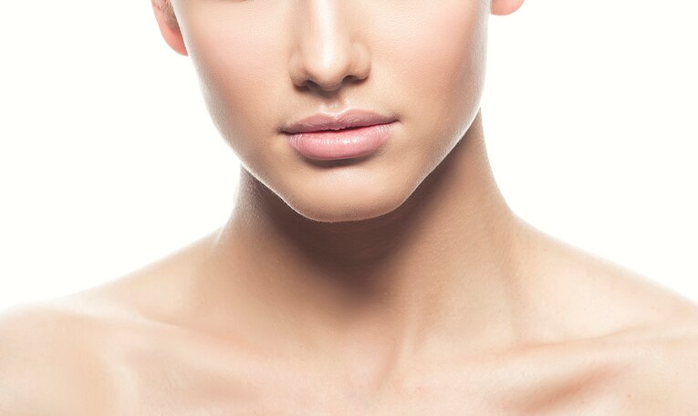 Beauty woman lips and neck. Natural nude make-up, clean skin. Facial skincare health treatment. White background