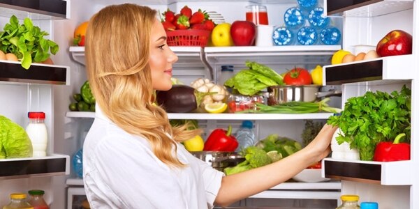 Happy female search something in the fridge, fresh fruits and vegetables in the refrigerator, cooking diet food, fit and body care concept