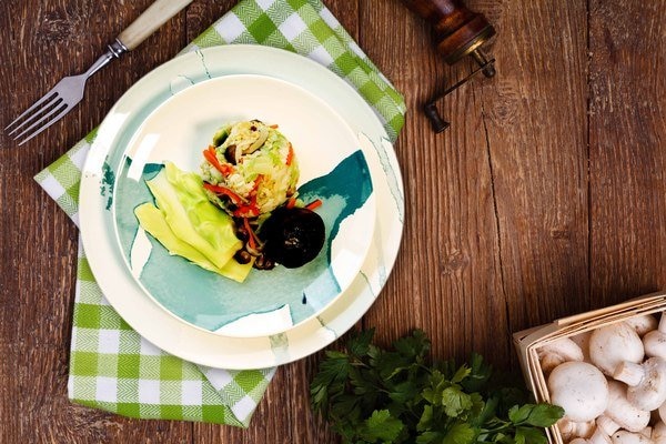 Steak with grilled potato, corn and tomato over wooden table. Top view with copy space