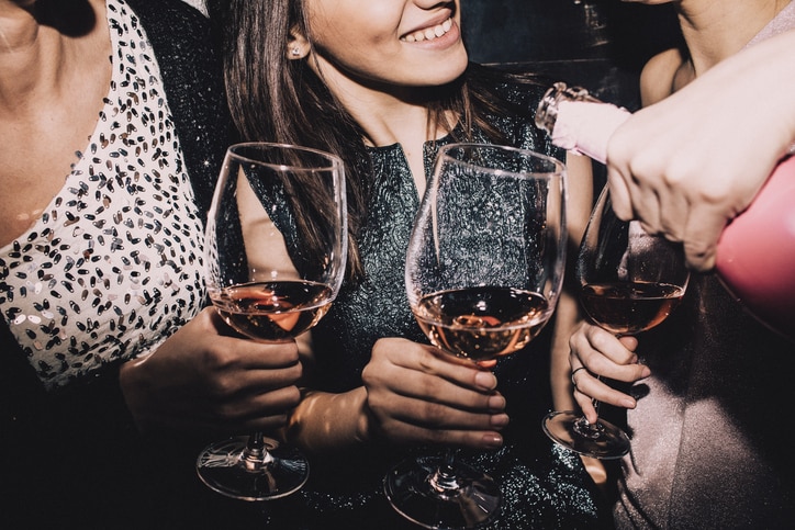 Photo of a young women enjoying each other's company while having a glass of champagne