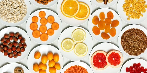 Set of orange products on wooden table, closeup